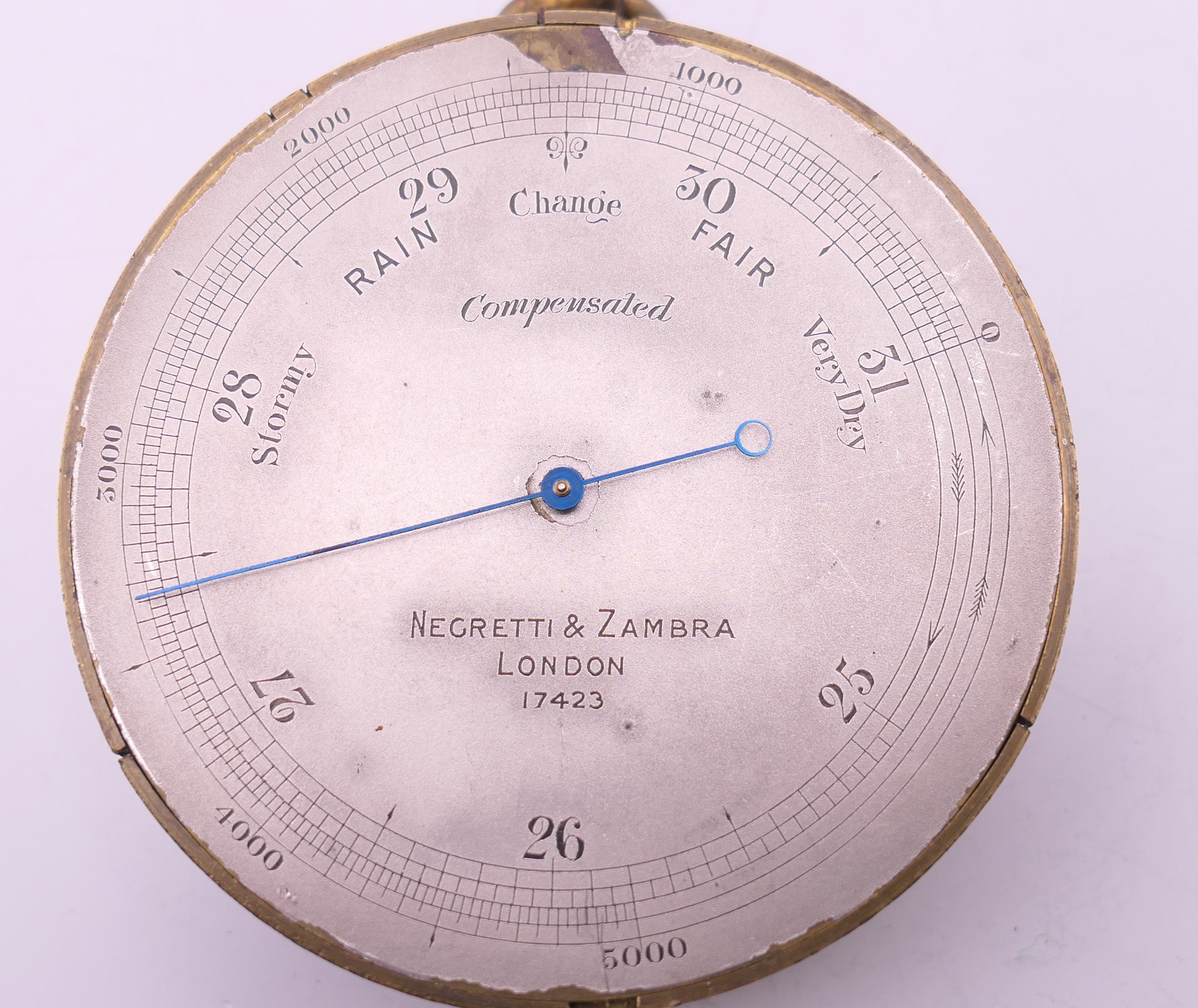 A Negretti & Zambra of London brass barometer, in original case, numbered 17423. 7 cm diameter. - Image 8 of 15
