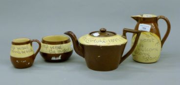 A Victorian Mottoware tea set. The teapot 23 cm long.