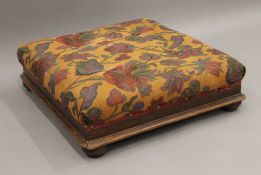 An upholstered Victorian mahogany footstool. 50 cm wide.