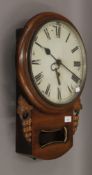 A Victorian mahogany cased drop dial wall clock with pendulum and original key. 36 cm diameter.