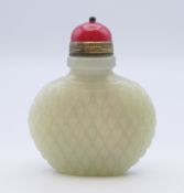 A Chinese white jade diamond cut pattern snuff bottle, with red stopper, Qing Dynasty.