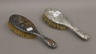 Two silver backed brushes. Each approximately 24.5 cm high.