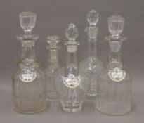 Five various cut glass decanters, three bearing Crown Staffordshire spirit labels.