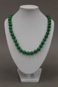 A string of jade beads. 82 cm long.