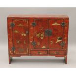 A chinoiserie lacquered side cabinet. 84 cm wide.