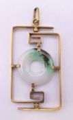 An unmarked gold and jade pendant. 3.75 cm high. 4.4 grammes total weight.