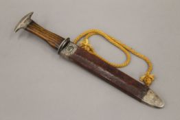 A silver mounted oak handled dagger in sheath. 38 cm long.