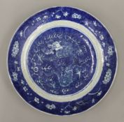 A Chinese blue and white crackle glaze porcelain dish decorated with a five claw dragon chasing a