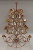 A metal Christmas tree candelabra with cut glass drops. 67 cm high.