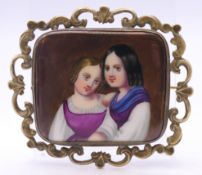 A 19th century brooch centred with a painted porcelain plaque depicting two young girls. 6 cm wide.