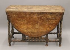 A large oak gate leg table. 113 cm long.