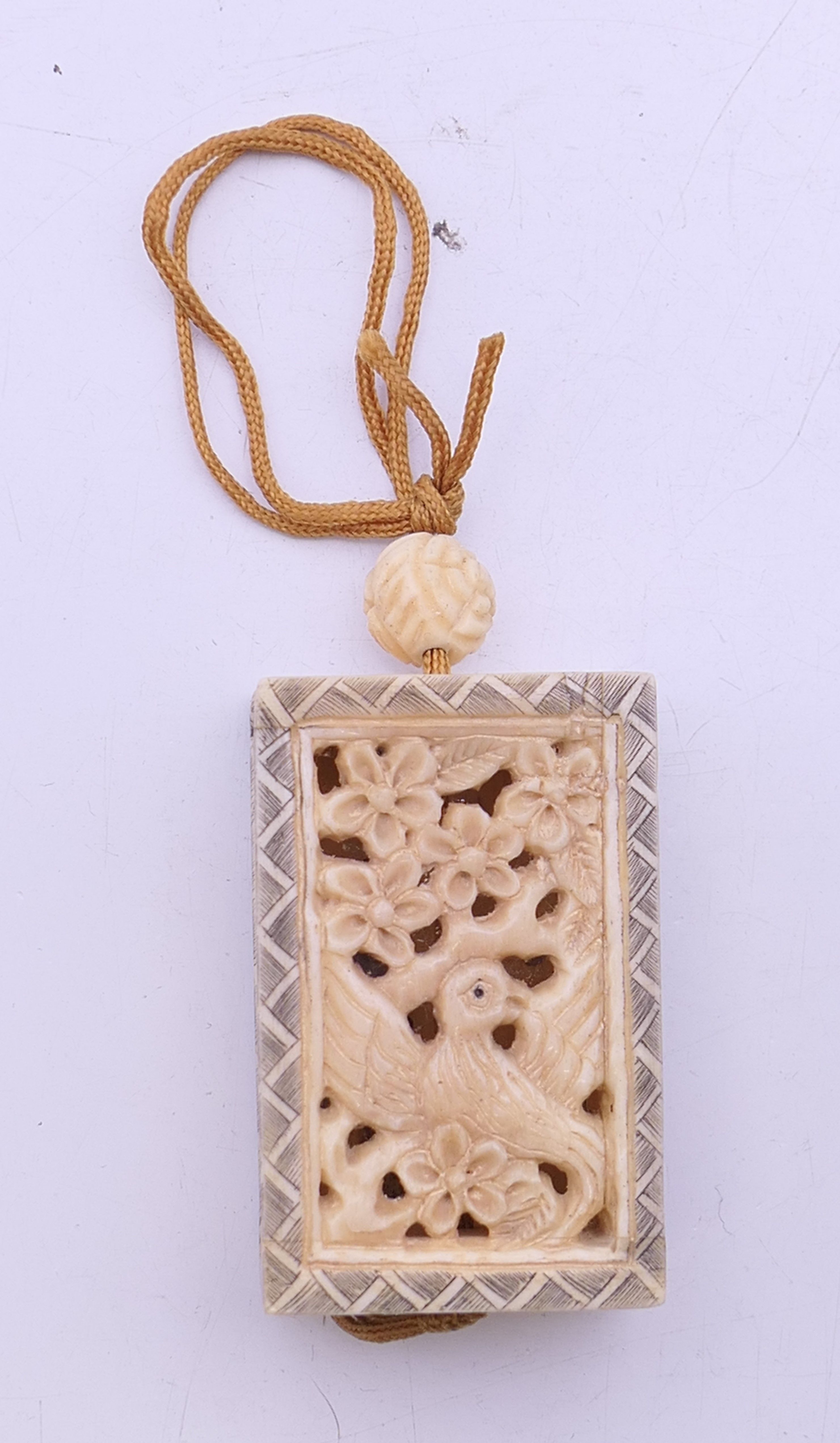A small carved bone inro. 3 cm x 4.5 cm.