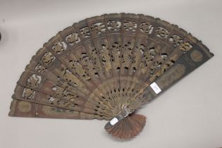 A Chinese wooden fan carved with eight Daoist Immortals. 48.5 cm high.