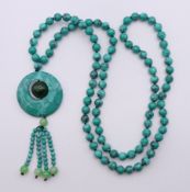 A turquoise pendant bead necklace. 84 cm long, pendant 10 cm high.
