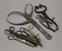 A collection of tools, including sugar snips, wick trimmers, blacksmith callipers, etc.