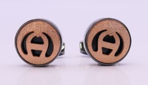 A pair of Aigner cufflinks, in a Penrose of London box. 1.75 cm diameter.