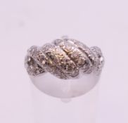 A platinum and diamond four row dress ring. Ring size K/L. 5.9 grammes total weight.