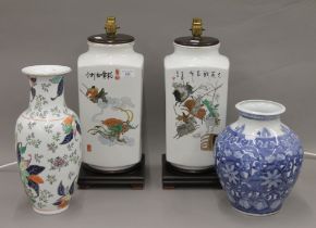 A pair of Chinese porcelain lamps and two porcelain vases. The former each 49 cm high.
