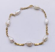 A 14 ct gold and pearl bracelet. 18.5 cm long.