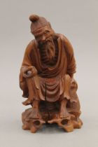 A Chinese carved wooden figure. 18 cm high.
