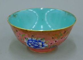 A Chinese pink ground porcelain bowl. 16 cm diameter.