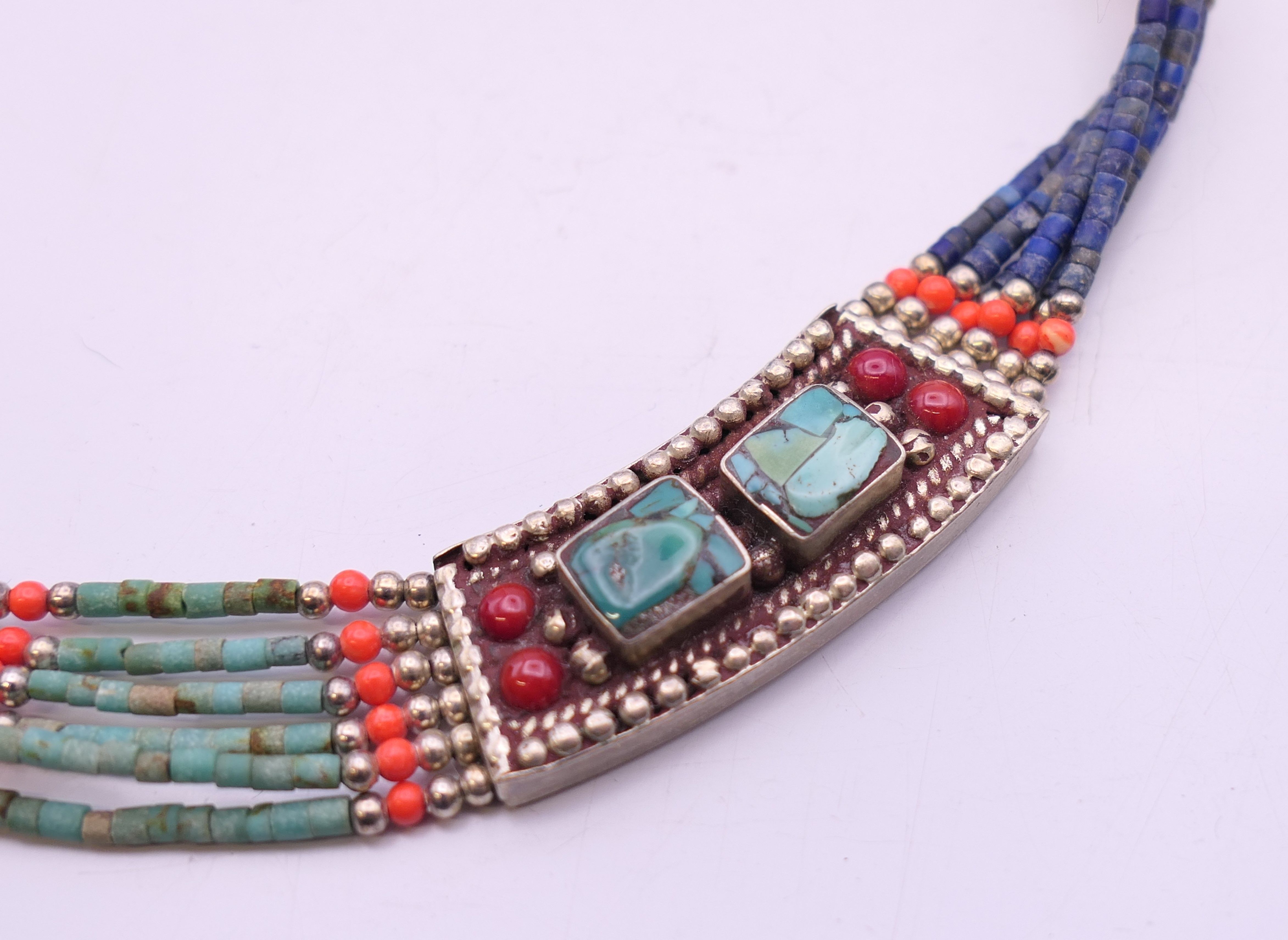 An unmarked silver turquoise and coral necklace. Approximately 50 cm long. - Image 6 of 6
