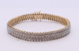 A 9 ct gold diamond line bracelet. Total diamond weight approximately 1.5 carats. 20.