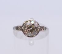 An Art Deco platinum diamond ring. Total diamond weight approximately 1.45 carats. Ring size L/M.