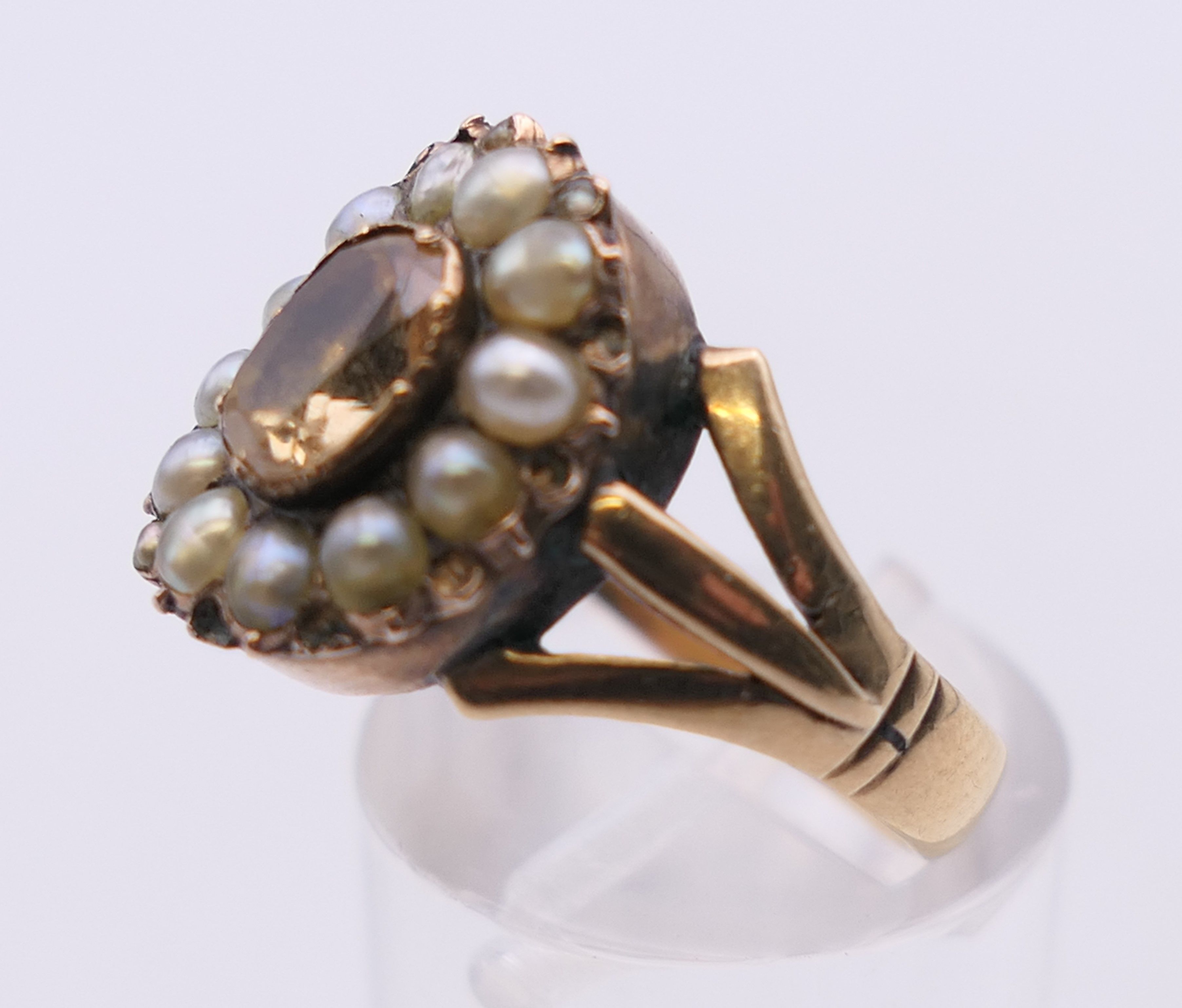 An antique unmarked gold Imperial topaz and seed pearl ring. Ring size N/O. 5. - Image 3 of 5