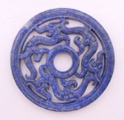 A Chinese carved lapis disc. 7 cm diameter.