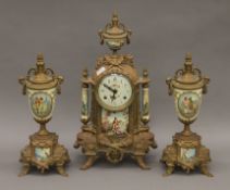 A three piece gilt metal mounted clock garniture. The clock 42 cm high.
