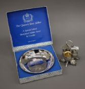 A thistle form silver plated cruet stand and a Queen Elizabeth II Silver Jubilee plated bowl.