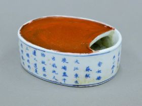 A Chinese blue and white porcelain inkstone with calligraphy. 13.5 cm long.