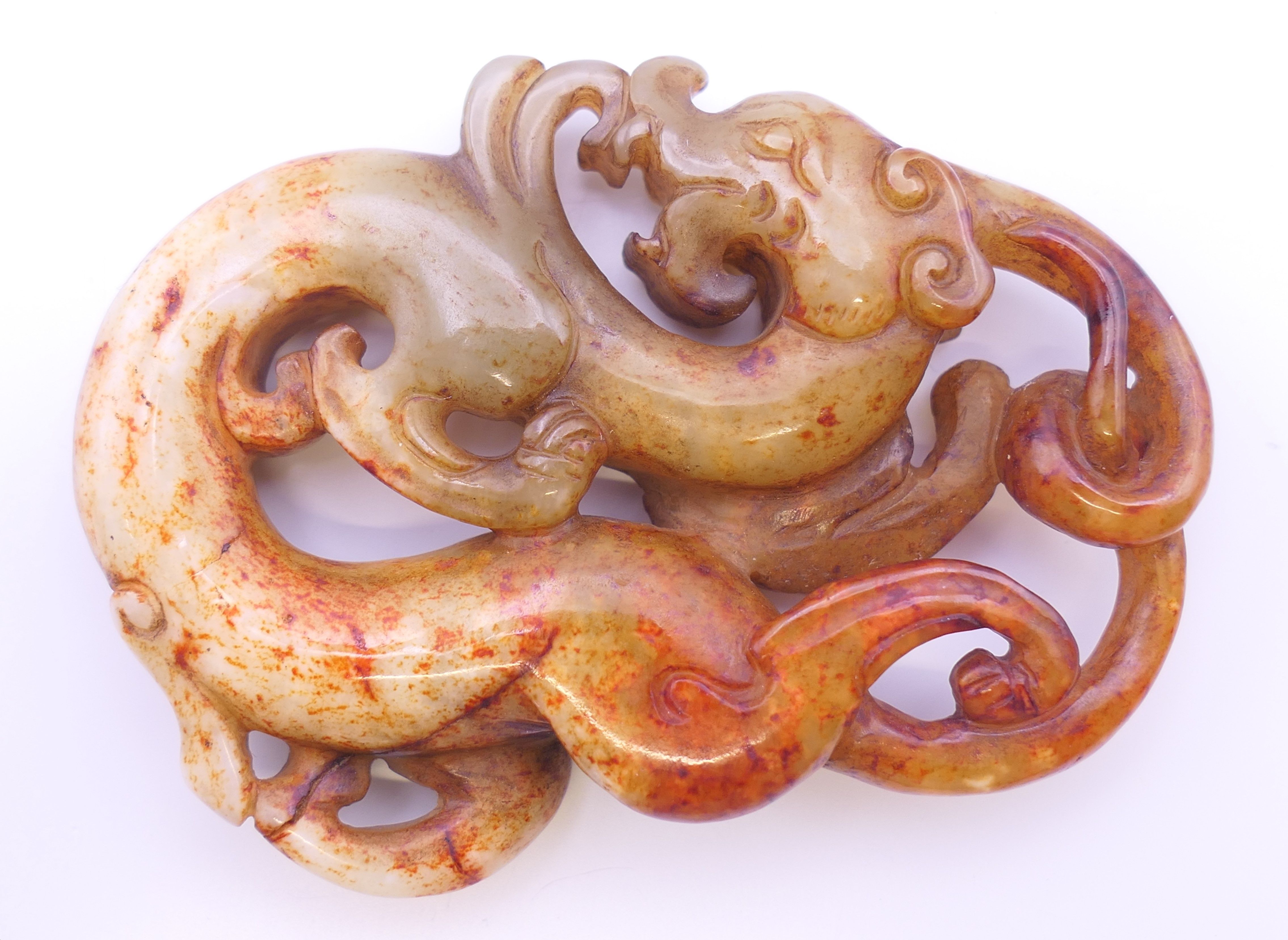 A Chinese white, yellow, green and red jade dragon pendant, Han Dynasty. 7 cm high.