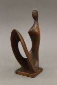 A carved wooden figural abstract figural sculpture. 18 cm high.