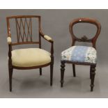 An Edwardian inlaid mahogany open armchair and a Victorian mahogany balloon back chair.