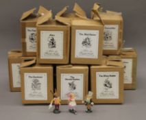 A quantity of modern painted metal Alice in Wonderland figures, each in original box.