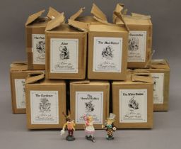 A quantity of modern painted metal Alice in Wonderland figures, each in original box.