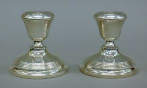 A pair of silver dwarf candlesticks. 7 cm high.