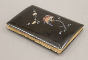 An Edwardian Japanese lacquer and mother-of-pearl postcard album containing various Oriental scenes,