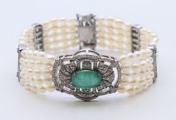 A diamond, emerald and pearl bracelet. 18 cm long.