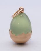 A 14 ct gold mounted egg pendant, bearing Russian marks. 2 cm high.
