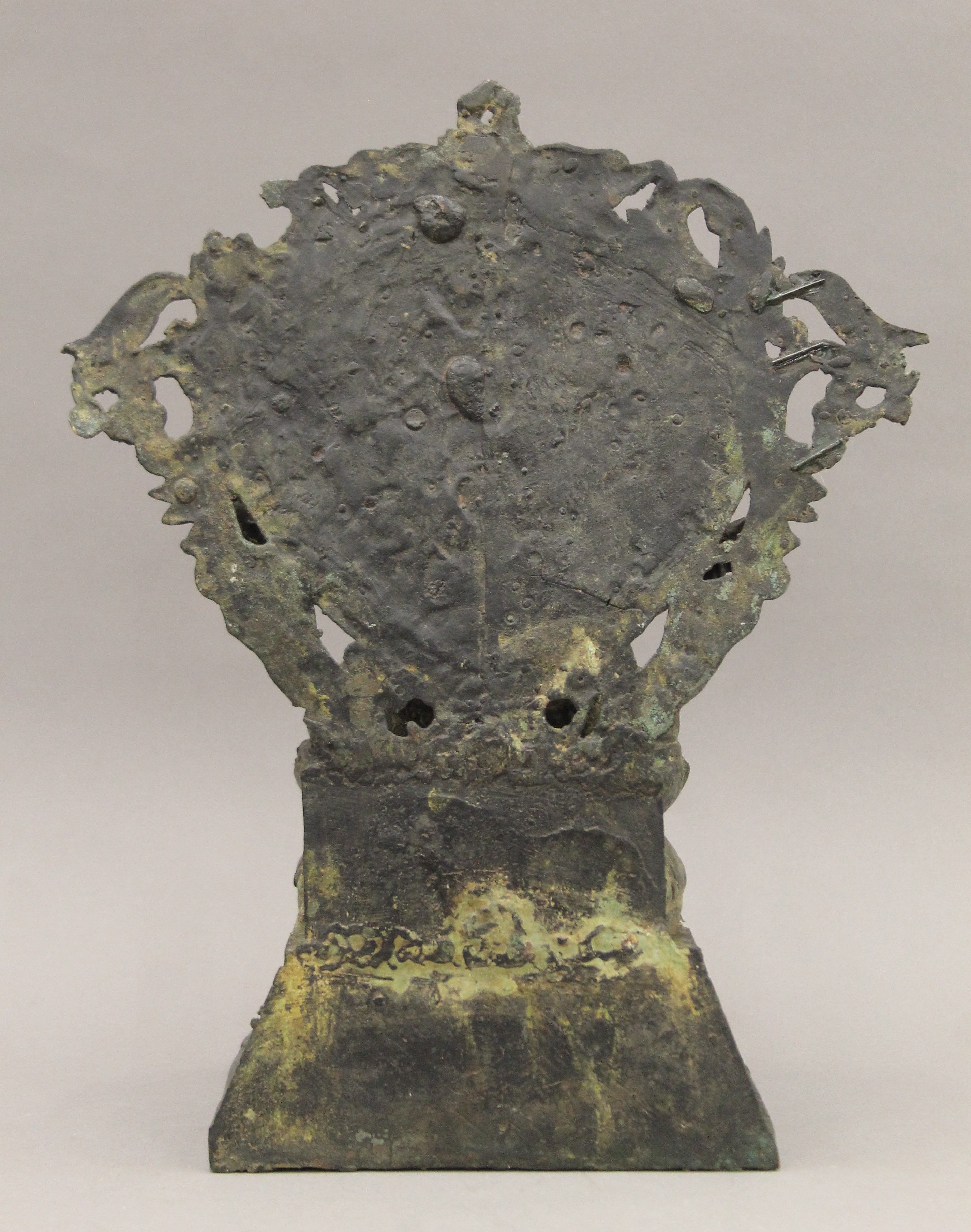 A Tibetan bronze figure of a six armed deity seated on a lotus leaf, on a stepped base. 34 cm high. - Image 4 of 5