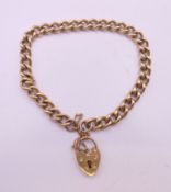 A 9 ct gold bracelet with padlock. 18 cm long. 15.2 grammes.