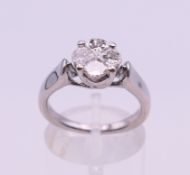 An 18 ct white gold diamond four stone cluster ring. Ring size M/N. 6.5 grammes total weight.