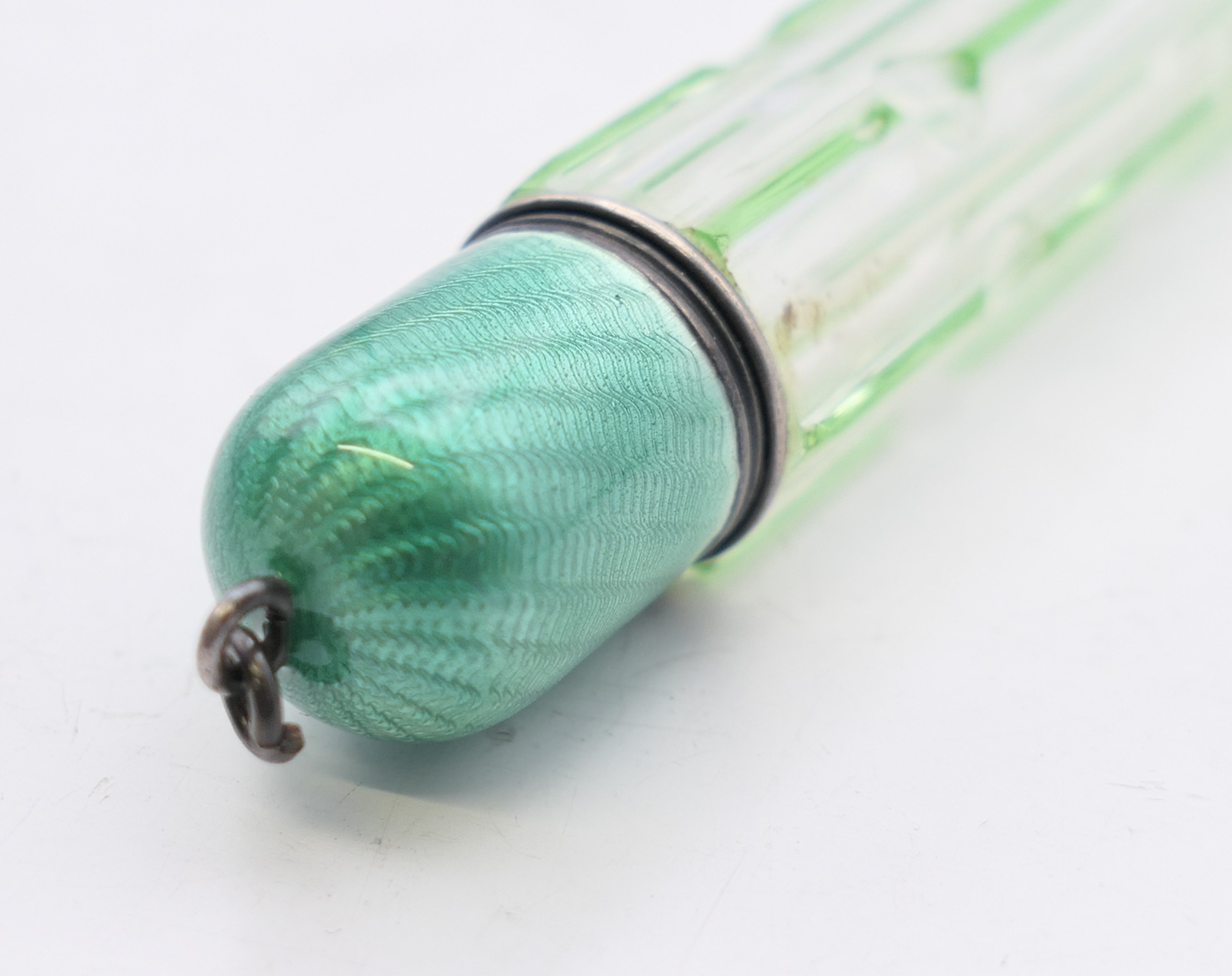 A green overlay glass scent bottle with enamel lid. 8 cm high. - Image 4 of 4