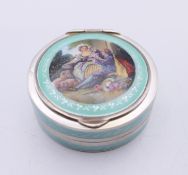 An early 20th century silver and enamel pill box, the lid decorated with a courting couple. 4.