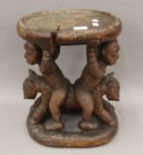 A late 19th/early 20th century African Yoruba Tribe stool/ceremonial table. 38 cm high.