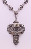 An Art Deco silver pendant necklace. 36 cm long, pendant 5.5 cm high.