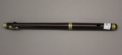 A vintage rosewood flute, signed G Butler & Sons (lacking end piece). 37.5 cm long.